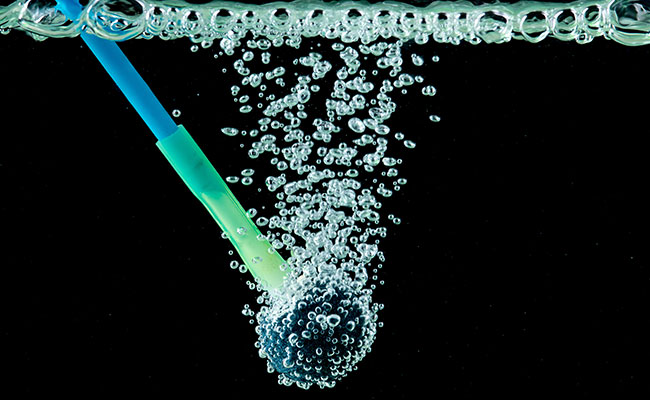 Aquarium airstone bubbler with airline tube on black background in water