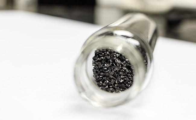 A glass jar filled with activated carbon