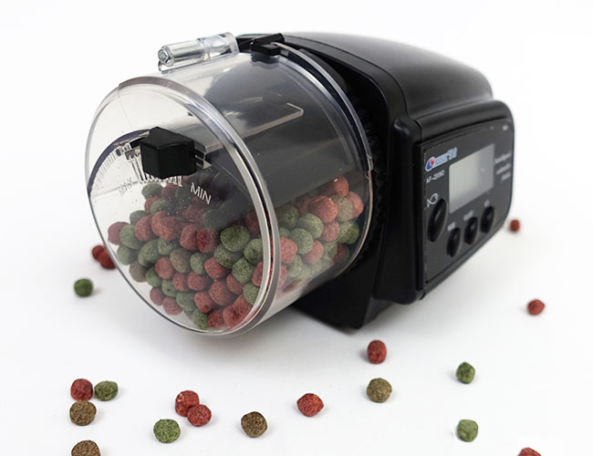 Automatic fish food feeder filled with fish food pellets
