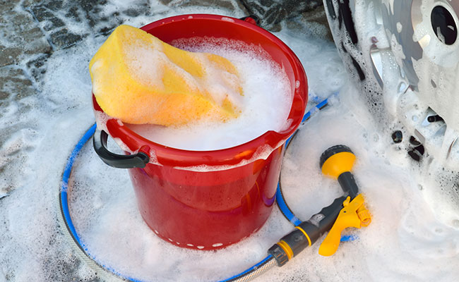 Bucket filled with soapy water to wash car