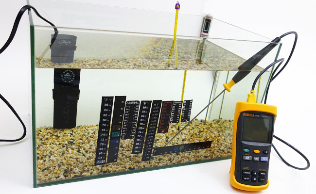 Testing stick on thermometer strips in aquarium with calibrated thermometer