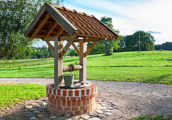 A well and bucket on rural property to draw water