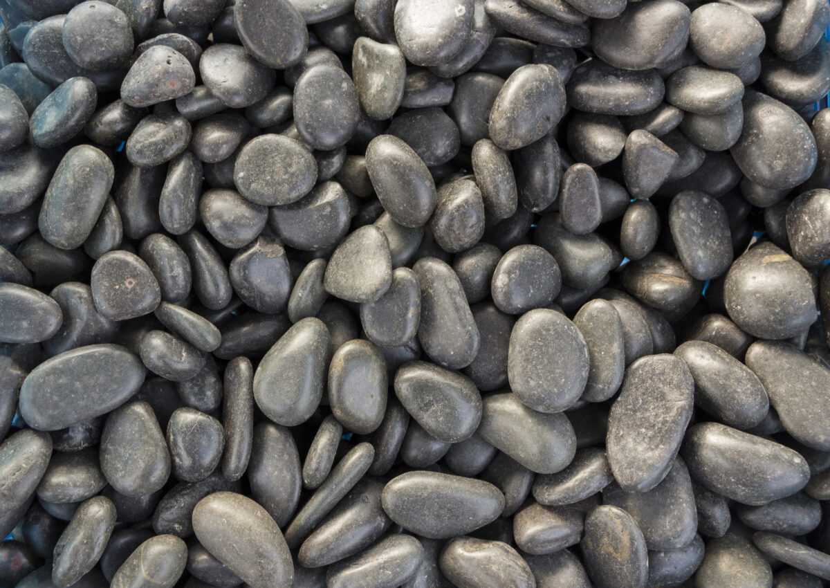 Polished colored marble pebbles and semi-precious stones background