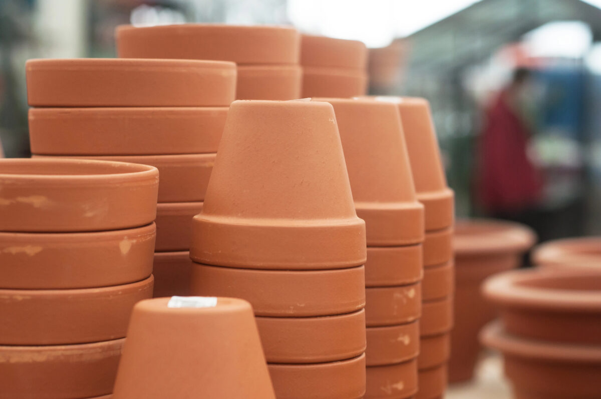 closeup of terra cotta pots pile in a green house